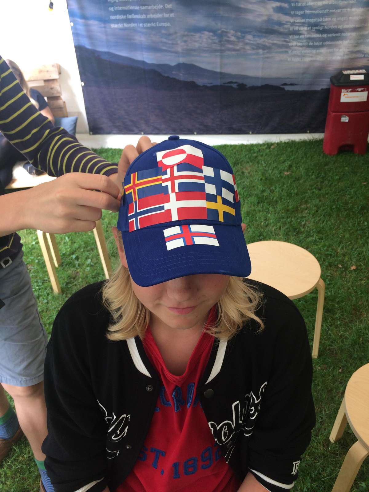 Young man, hat with nordic flags
