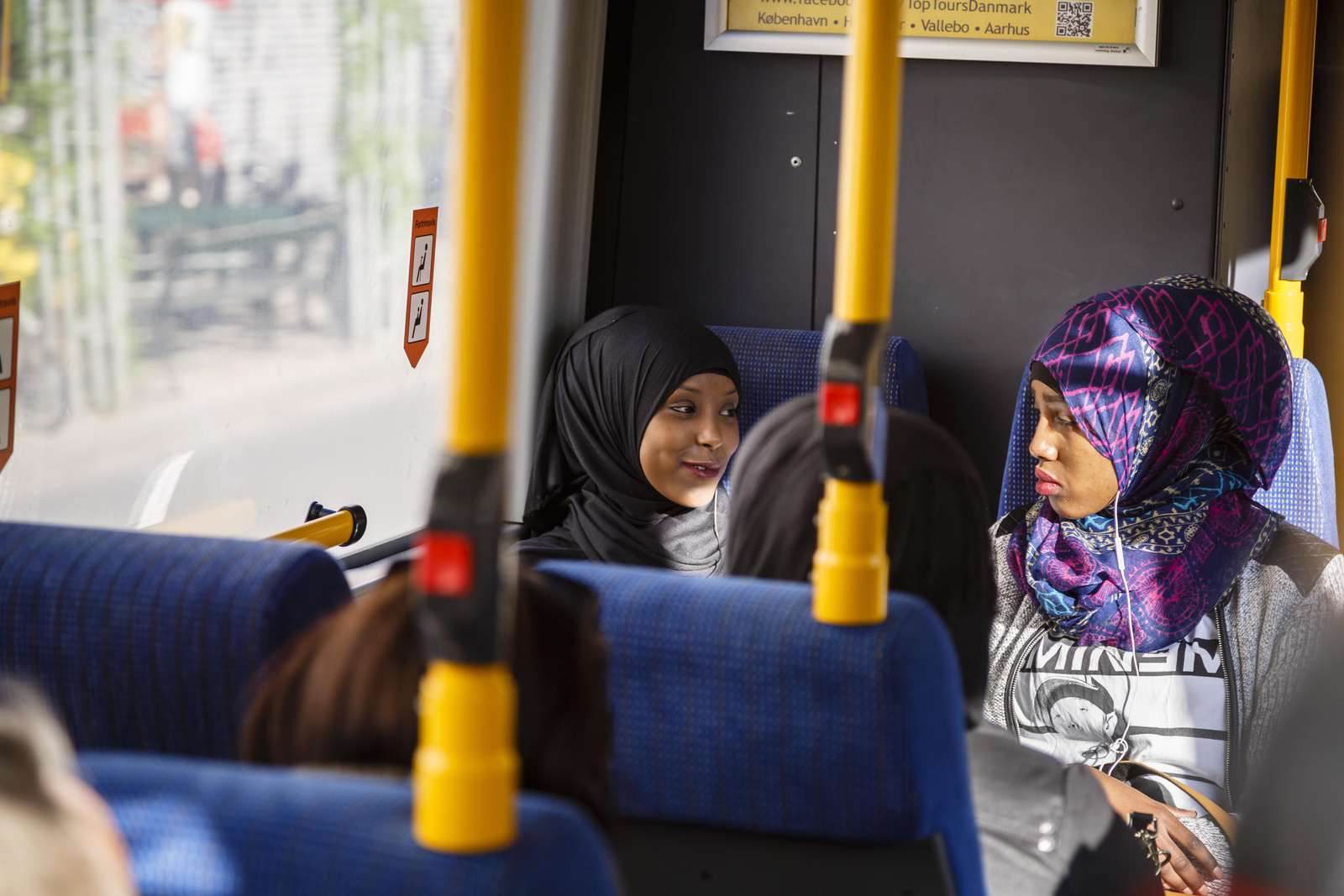 Two women sitting on a bus