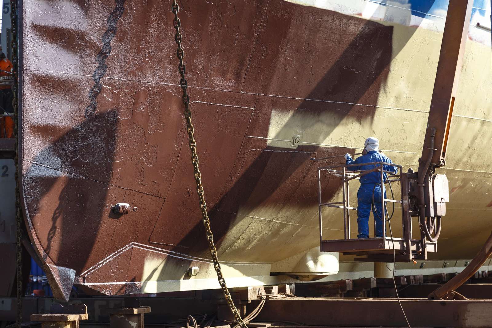 Man painting ship