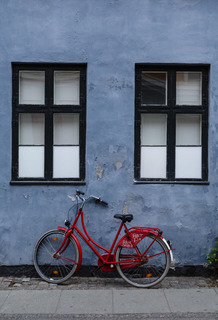 Red bicycle and blue wall