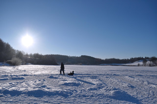 Sledding on a frozen lake