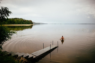 Finnish man swimming in lake