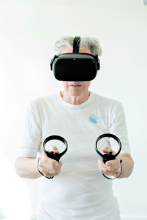Elderly man testing VR game