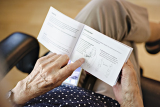 Elderly woman reading instruction