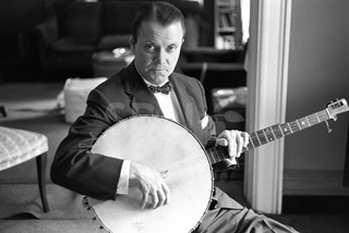 Eddie Condon. Practicing banjo at his home in, New York, 1960