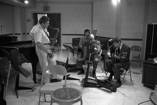 Joe Venuti, Zoot Sims, and Bucky Pizzarelli. Practicing in a rehearsal room, New York, 1975