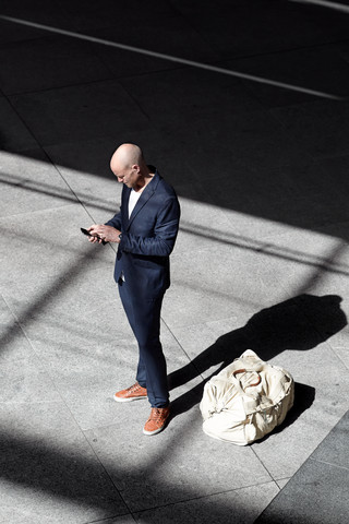 Man standing with smartphone