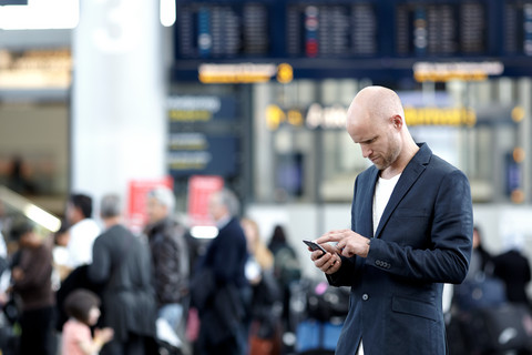 Man in airport with mobile