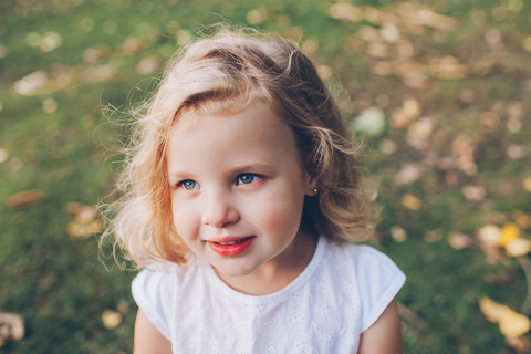 portrait of a little blond girl outdoors