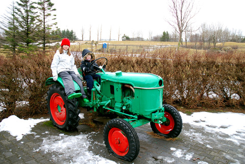 Two kids on a tractor