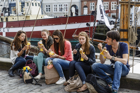 Young people eating ice-cream by the harbour