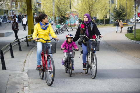 Women and child on bikes