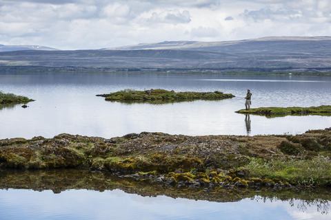 Man fishing at Thingvallavatn lake, Iceland