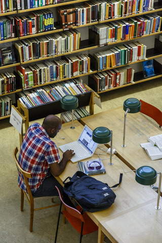 Man on laptop in library