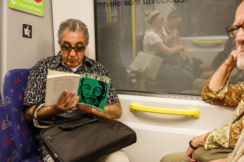 Man reading a book on a train