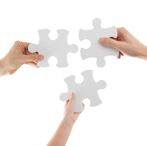 Hands Holding Puzzle Pieces