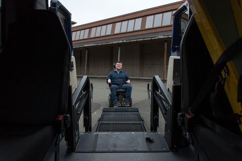 Young man in wheelchair  - ramp to car