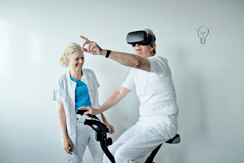 Elderly man testing VR gaming