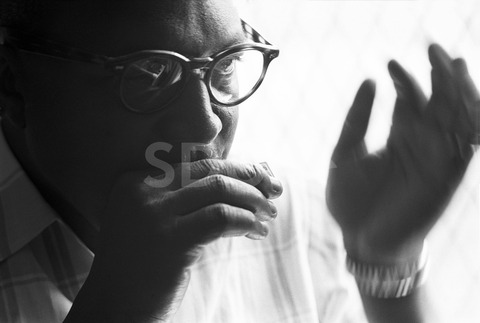 Sonny Terry. Playing the harmonica at his home in Harlem, New York, 1960