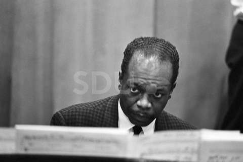Hank Jones. Playing the piano in an unknown place