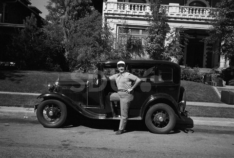 Flip Phillips. In front of his car at his home, Denver, 1975