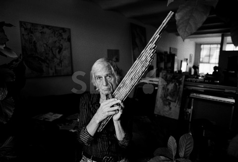 Gil Evans. Practicing on a plan flute at his home, New York, 1975
