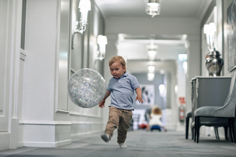sebastian kicking ball in corridor