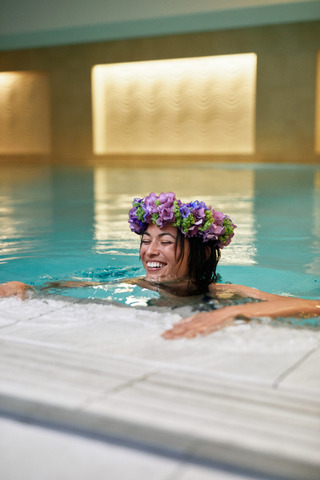 model in pool with flower head band 