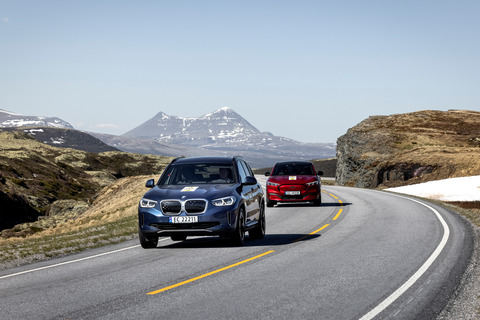 BMW iX3 and Ford Mustang Mach-e in the mountains.
