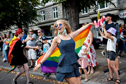 Girl dancing with rainbow flag