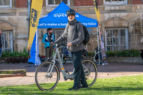 Making cycling e-asier beneficiary Zafar Saleem stands next to his free one month e-cycle loan from Leicester Bike Park community hub. Taken Monday, 20 Feb 2023. Credit: Leicester City Council