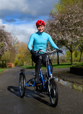Dame Sarah Storey sits on a blue e-trike in Debdale Park, Manchester. Public event took place to mark the launch of Making cycling e-asier at Wheels for All.
