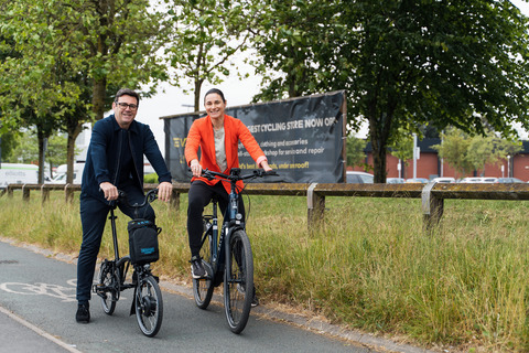 Andy Burnham, Mayor of Greater Manchester left and Dame Sarah Storey, Active Travel Commissioner for Greater Manchester right, sit side by side on e-bikes on a cycle lane in Cheetham Hill, Manchester