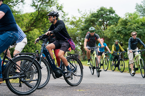 Participants pedal through Debdale Park during Making cycling e-asier 55km relay around Manchester to highlight the benefits of e-cycles