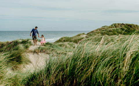 Father and daughter in the dunes on the Danish coast 7